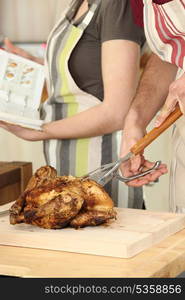 Man cutting chicken on a cutting board