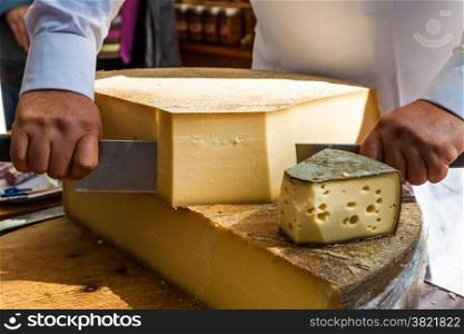 Man cutting piece of cheese
