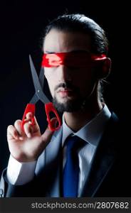 Man cutting ribbon on his eyes