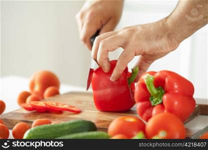 man cutting vegetables for salad