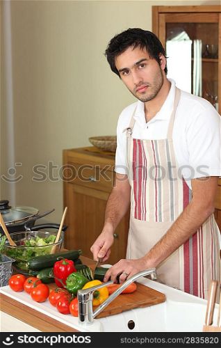 Man cutting vegetables on a chopping board
