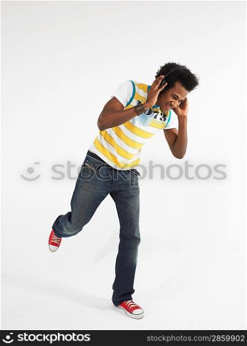 Man dancing while wearing headphones in studio