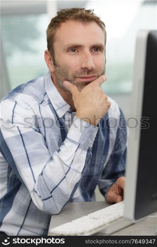 man deep in thought while using the computer