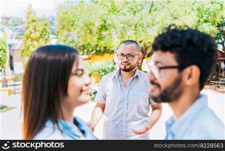 Man discovering his cheating girlfriend with another man outdoor, Boyfriend discovering his girlfriend&rsquo;s infidelity outdoors. Man looking at his cheating girlfriend with another man outdoors