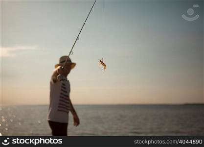 Man displaying lure on fishing line
