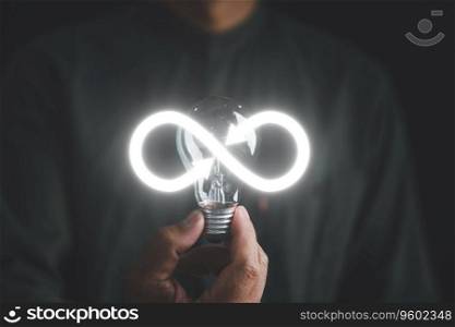 Man displays light bulb with infinite symbol icon, representing creative new idea. Innovation, unlimited brainstorming, inspiration, and solution. Development and data exchange for business growth.