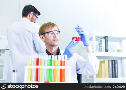 Man doctor as male scientist team doing some research working conduct experiments in modern laboratory / Scientists in lab biochemistry genetics forensics microbiology and test tube