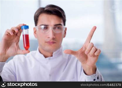 Man doctor checking blood samples in lab