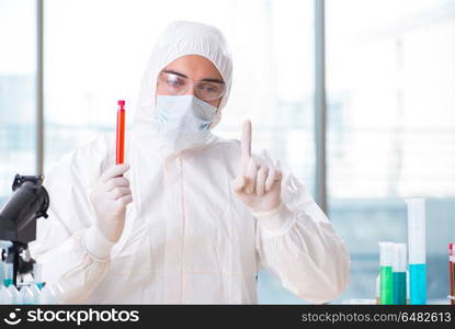 Man doctor checking blood samples in lab