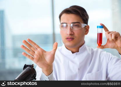 Man doctor checking blood samples in lab