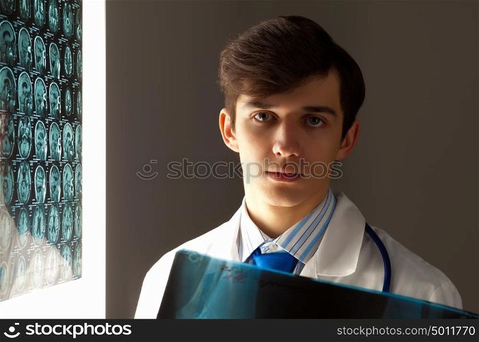 Man doctor holding x-ray results. Image of male doctor holding x-ray results