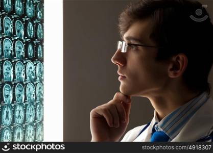 Man doctor looking at x-ray. Image of male doctor looking at x-ray results