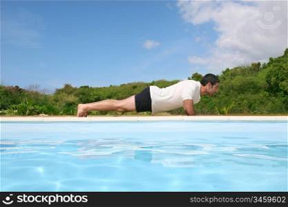 Man doing exercises by the pool