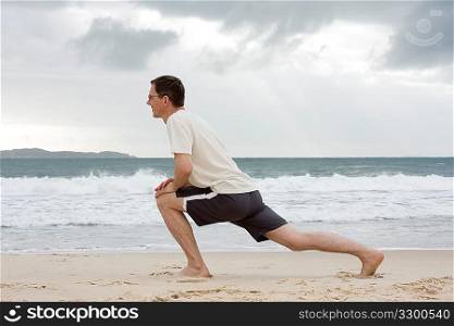 Man doing fitness exercises on a beach