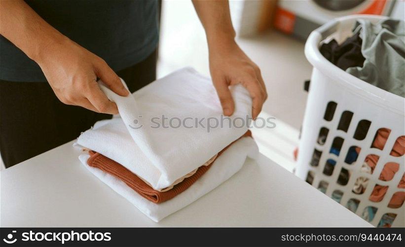 Man doing launder holding basket with dirty laundry of the washing machine in the public store laundry clothes 