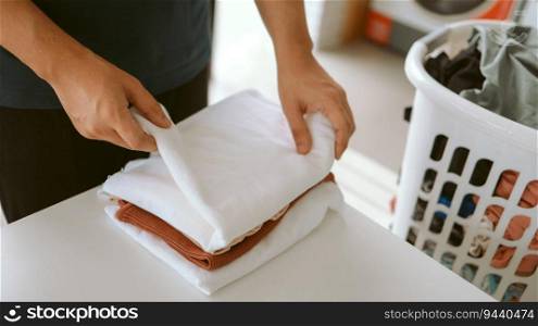 Man doing launder holding basket with dirty laundry of the washing machine in the public store laundry clothes 