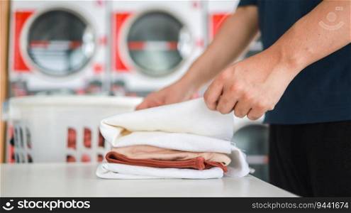 Man doing launder holding basket with dirty laundry of the washing machine in the public store. laundry clothes 