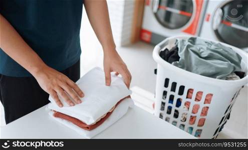 Man doing launder holding basket with dirty laundry of the washing machine in the public store. laundry clothes 