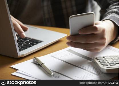 Man Doing On Line Banking And Finance At Home