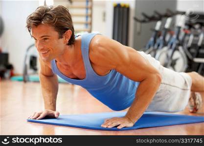 Man Doing Press Ups In Gym