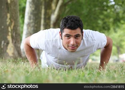 Man doing press ups in the park