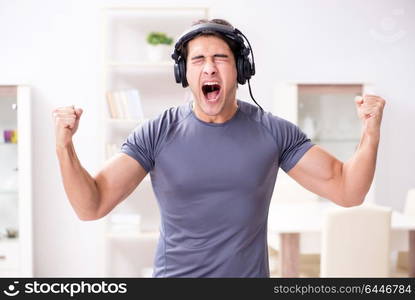 Man doing sports at home and listening to music