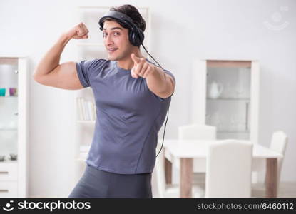 Man doing sports at home and listening to music