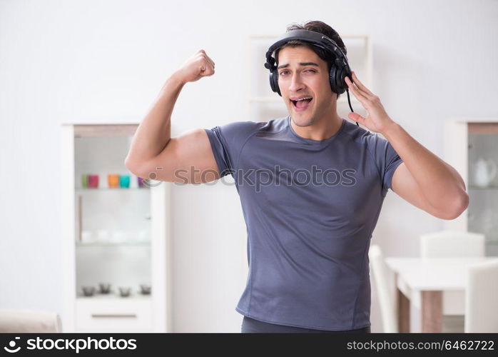 Man doing sports at home and listening to music