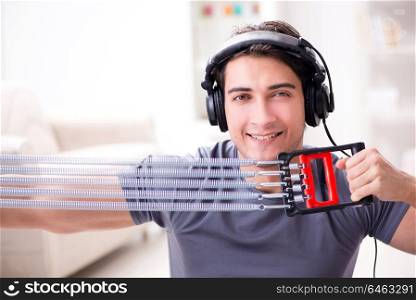 Man doing sports with resistance band and listening to music