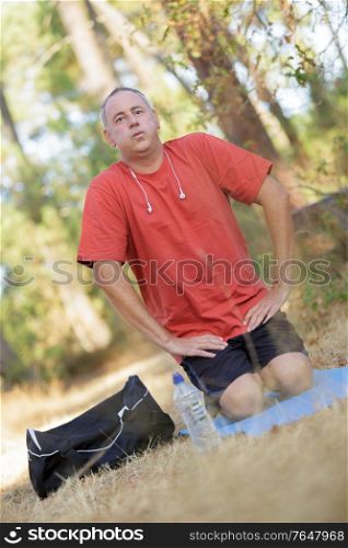 man doing stretching before outdoor exercise