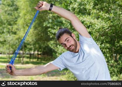man doing stretching with rubber band