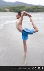 Man Doing Yoga on Beach
