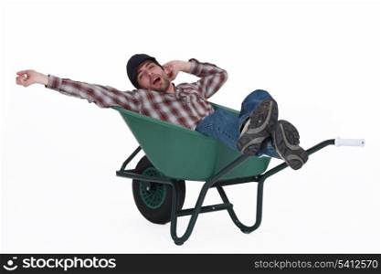 Man dozing in a wheelbarrow