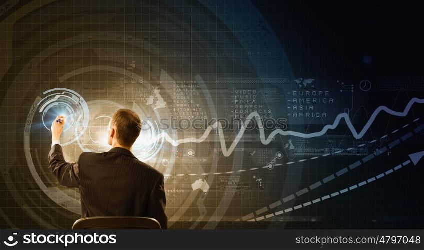 Man draw on screen. Rear view of businessman drawing with marker on virtual panel