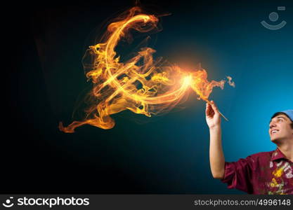 Man drawing euro symbol. Guy painter drawing dollar sign on dark background