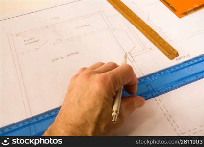Man drawing on blueprint