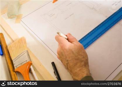 Man drawing on blueprint