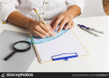 man drawing with straightedge