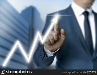 Man draws stock price touchscreen concept. Man draws stock price touchscreen concept.