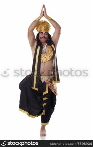 Man dressed as Raavan in yoga pose