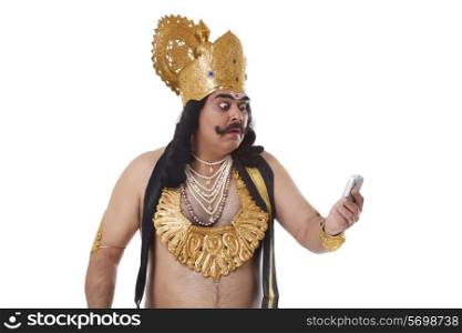 Man dressed as Raavan reading an sms