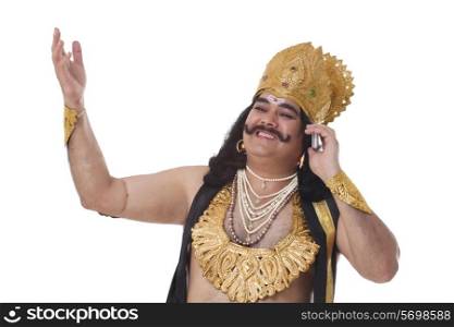 Man dressed as Raavan talking on a mobile phone