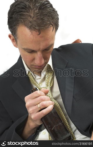 Man dressed in suit and tie falling asleep still holding his beer