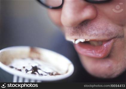 Man Drinking a Creamy Coffee Drink