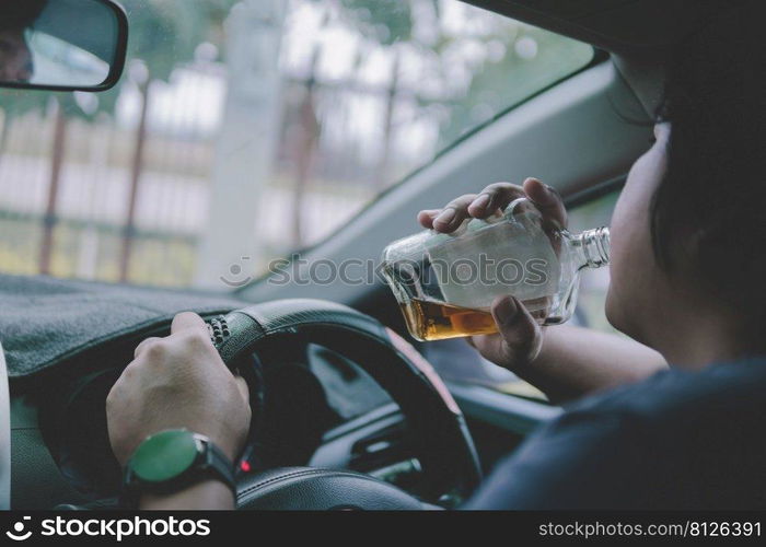 Man drinking alcohol while driving in his car