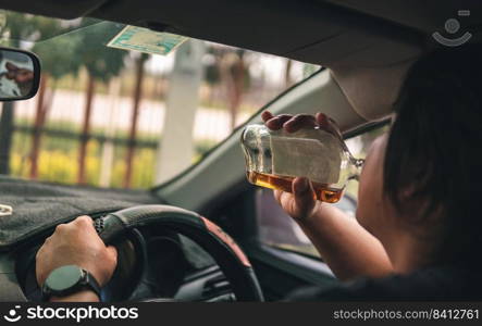 Man drinking alcohol while driving in his car