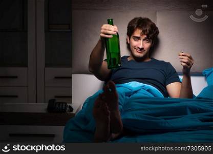 Man drinking in the bed under stress
