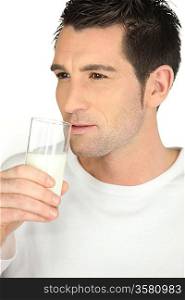 Man drinking milk on white background