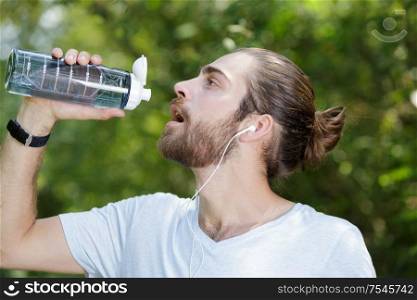 man drinking water after exercises
