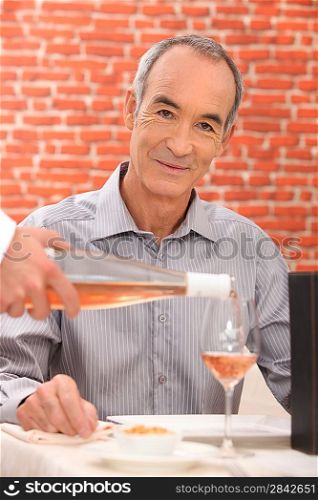 Man drinking wine in a restaurant